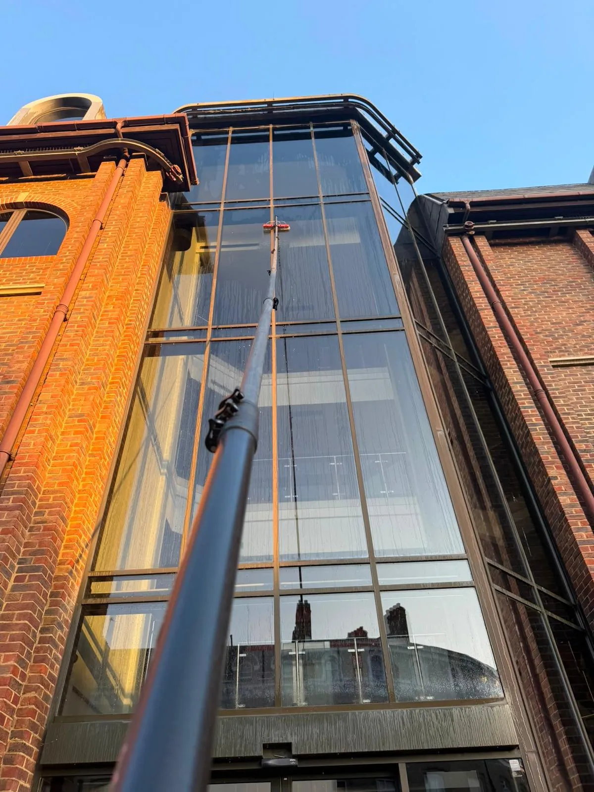 Commercial high-level atrium glazing cleaned by Crystal Clear