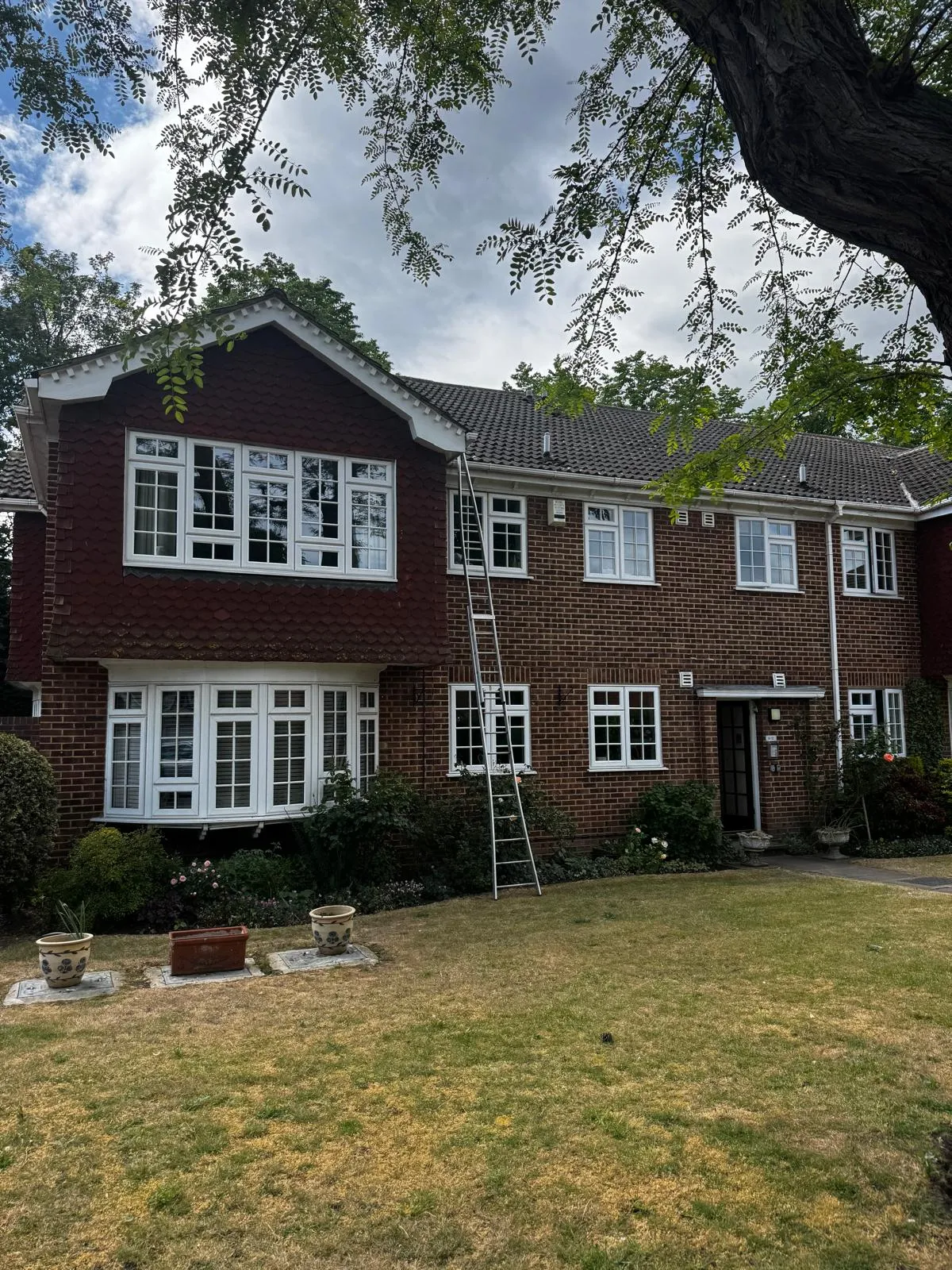 Clean windows on a tile-hung family home in Essex